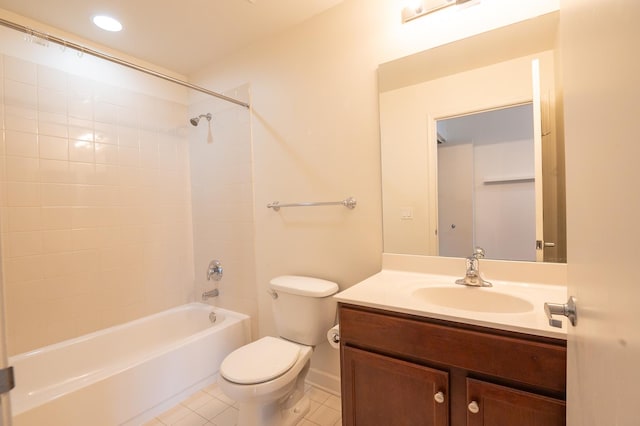 full bathroom featuring tile patterned flooring, vanity, tiled shower / bath, and toilet