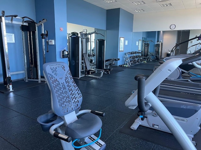 gym with a paneled ceiling