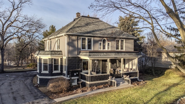 back of property with covered porch