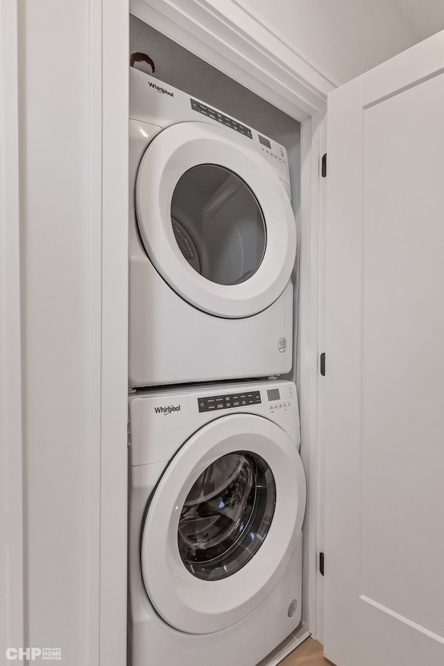 laundry room with stacked washing maching and dryer