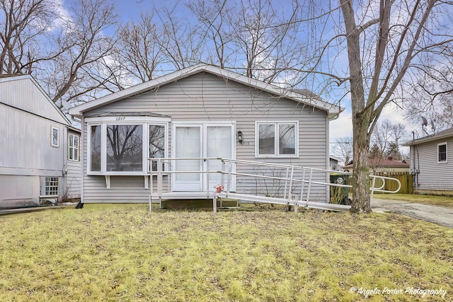 back of house featuring a lawn