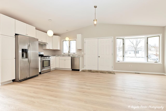 kitchen featuring stainless steel appliances, sink, hanging light fixtures, and white cabinets