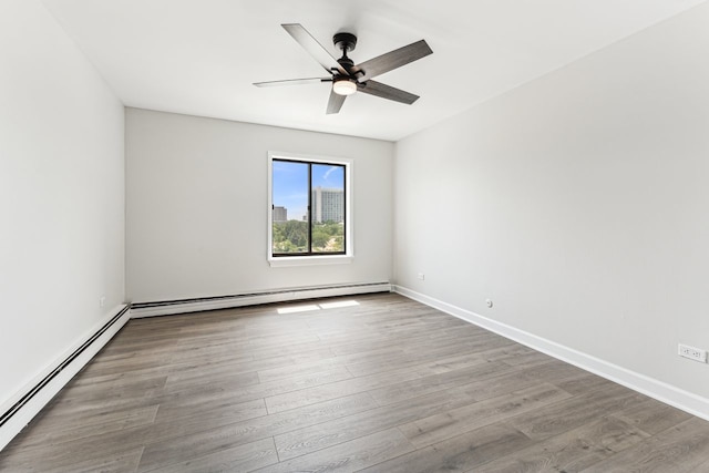 empty room featuring ceiling fan, a baseboard radiator, and light wood-type flooring