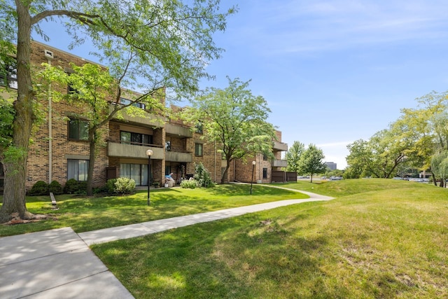 view of home's community with a lawn