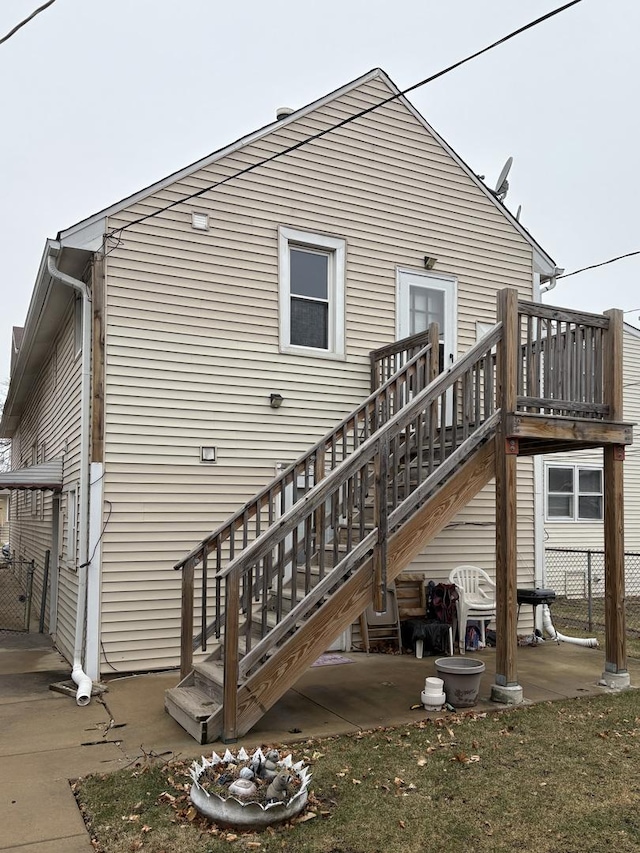 back of property featuring a patio and a deck