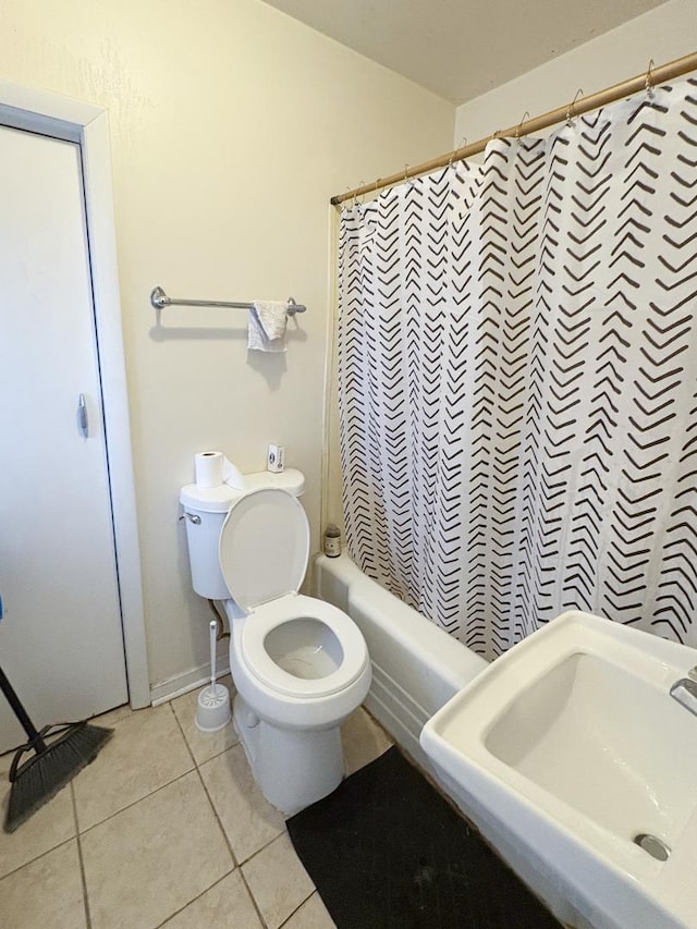 full bathroom featuring sink, toilet, tile patterned flooring, and shower / bath combo with shower curtain