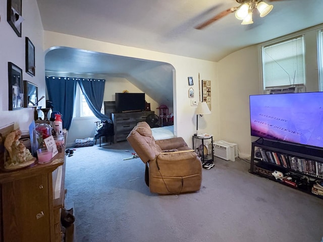 interior space featuring vaulted ceiling, ceiling fan, and carpet