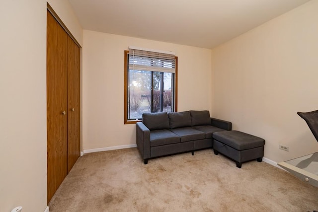 living room with baseboards and light colored carpet