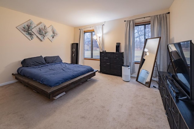 bedroom featuring carpet and baseboards