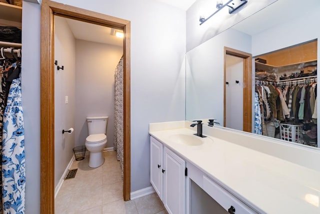 full bath featuring tile patterned flooring, baseboards, vanity, and toilet