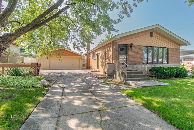 view of front facade with an outbuilding, a garage, and a front lawn