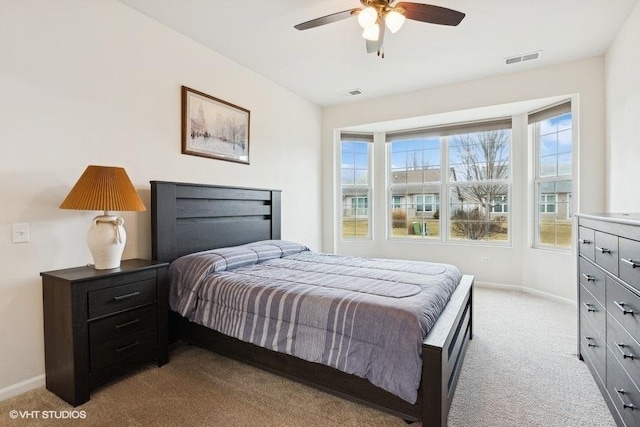 bedroom featuring light carpet and ceiling fan