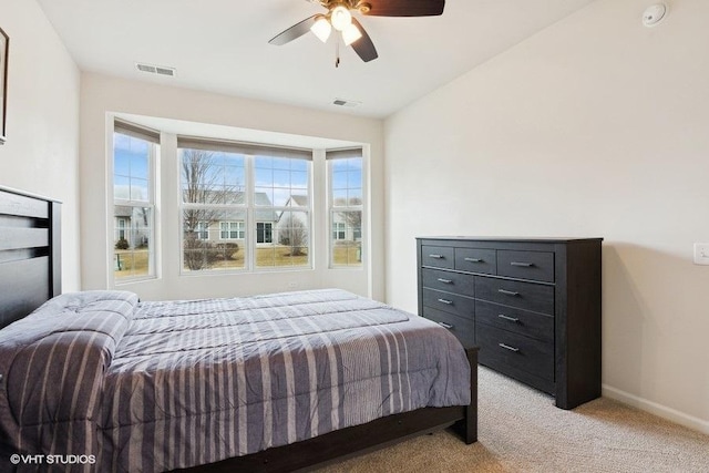 bedroom featuring ceiling fan, light colored carpet, and lofted ceiling