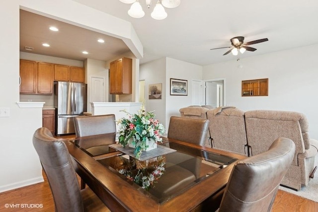 dining space featuring wood-type flooring and ceiling fan