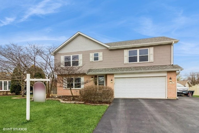 view of front facade with a garage and a front lawn