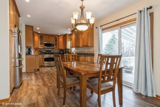 dining room with an inviting chandelier and wood-type flooring