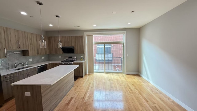 3541 S Maplewood Ave Unit 2, Chicago, IL 60632 - kitchen featuring light countertops, stove, a sink, modern cabinets, and dishwasher