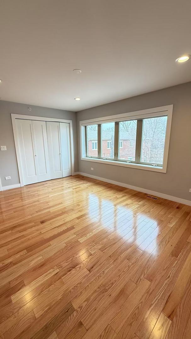 unfurnished bedroom featuring a closet, recessed lighting, light wood-style flooring, and baseboards