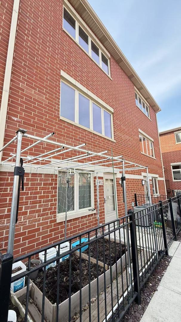 3541 S Maplewood Ave Unit 2, Chicago, IL 60632 - view of front of home featuring brick siding and fence