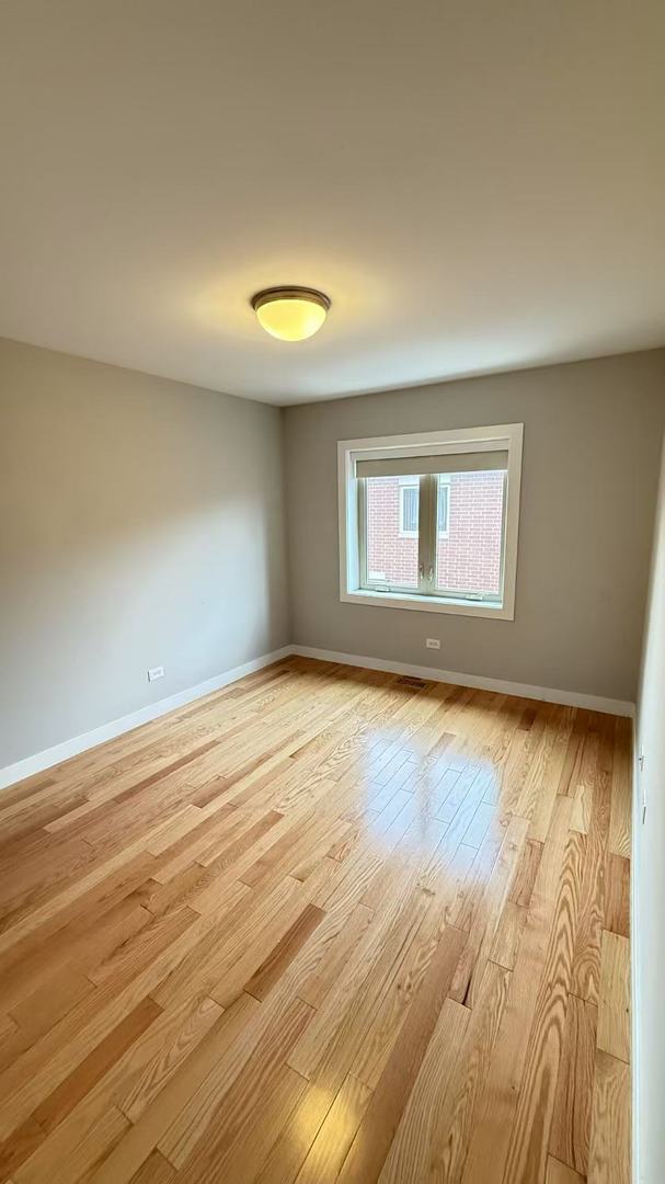 3541 S Maplewood Ave Unit 2, Chicago, IL 60632 - empty room with light wood-style flooring and baseboards