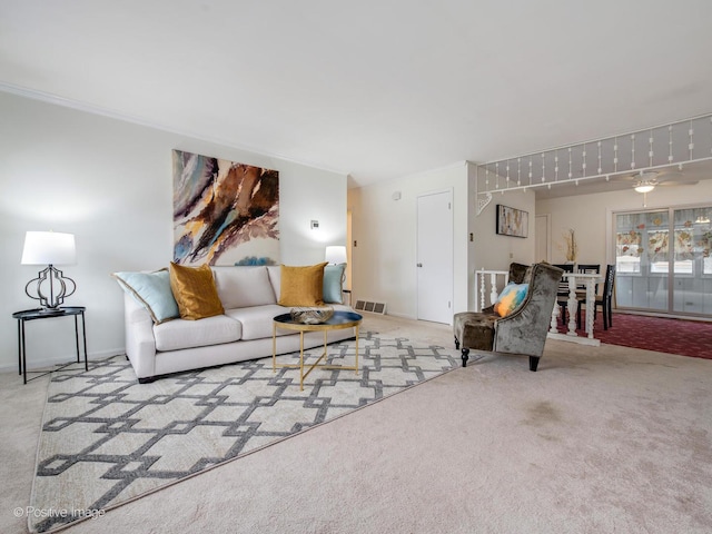 carpeted living room featuring ornamental molding