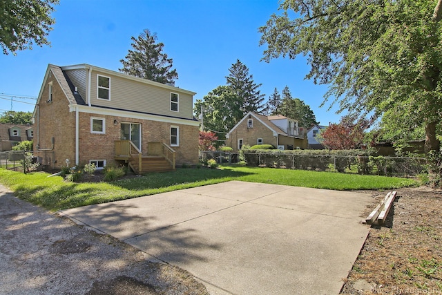 back of property featuring a lawn