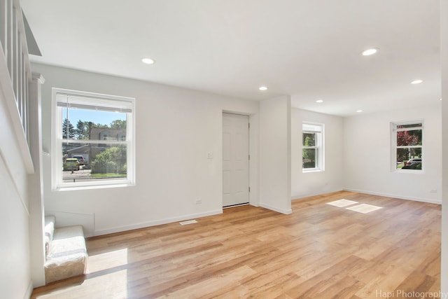 unfurnished living room with light wood-type flooring