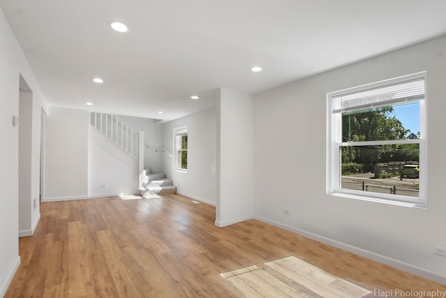 unfurnished living room with a wealth of natural light and light wood-type flooring