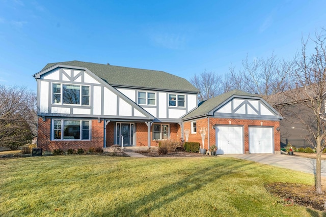 tudor home with a garage and a front yard