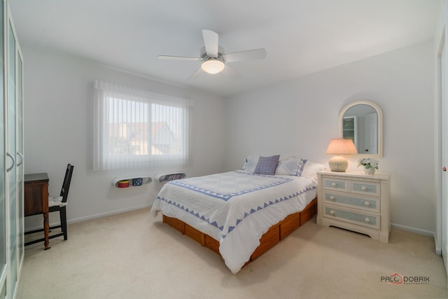 bedroom featuring light carpet and ceiling fan