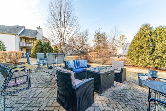 view of patio featuring an outdoor living space with a fire pit