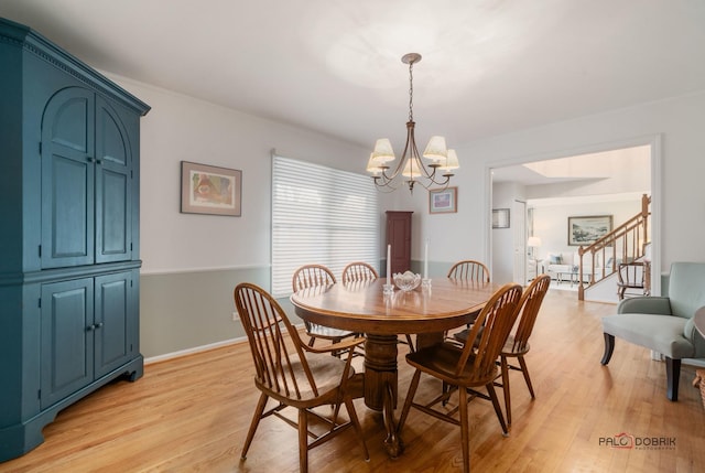 dining area featuring a chandelier and light wood-type flooring