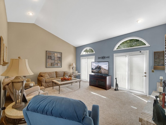 carpeted living room with vaulted ceiling