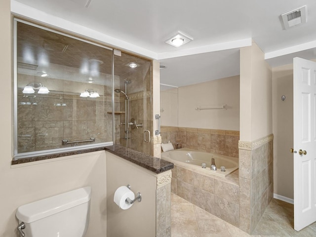 bathroom featuring tile patterned flooring, plus walk in shower, and toilet