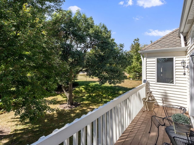 wooden deck featuring a yard