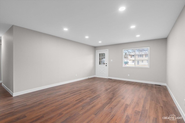 spare room with dark hardwood / wood-style flooring