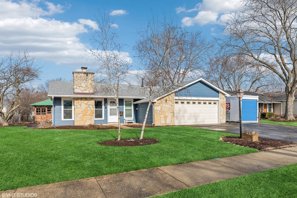 ranch-style home featuring a garage and a front yard