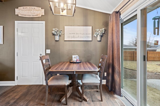 dining area with wood-type flooring and ornamental molding