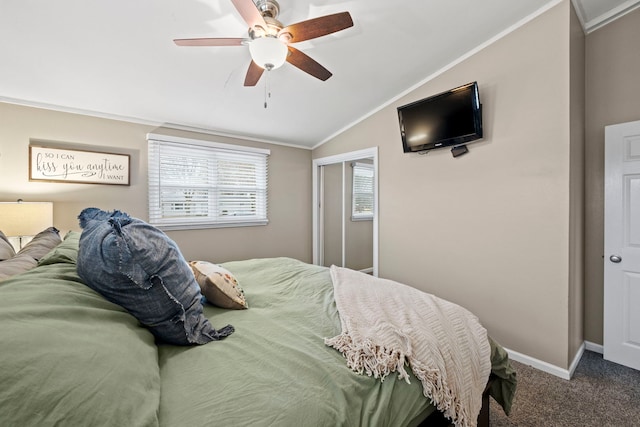 carpeted bedroom featuring lofted ceiling, ornamental molding, a closet, and ceiling fan