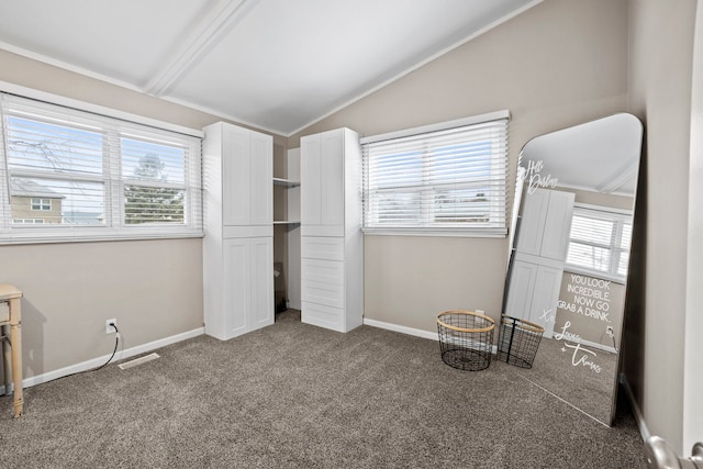 unfurnished bedroom with lofted ceiling and dark colored carpet