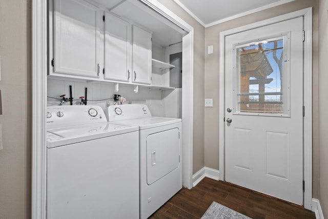 clothes washing area with dark hardwood / wood-style flooring, washer and clothes dryer, ornamental molding, and cabinets