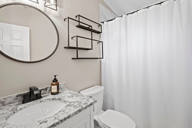 bathroom with vanity, a shower with shower curtain, and toilet