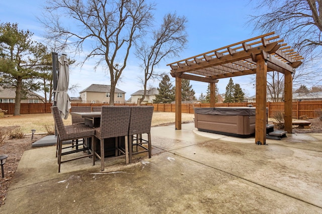 view of patio / terrace with a hot tub and a bar