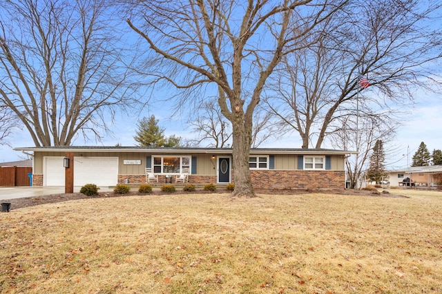 ranch-style home featuring a garage, a porch, and a front lawn