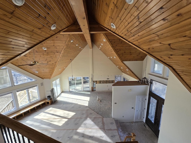 interior space featuring beam ceiling, a notable chandelier, wood ceiling, and high vaulted ceiling