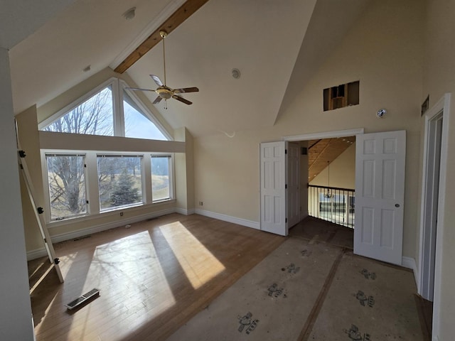 living room with hardwood / wood-style flooring, high vaulted ceiling, and beam ceiling