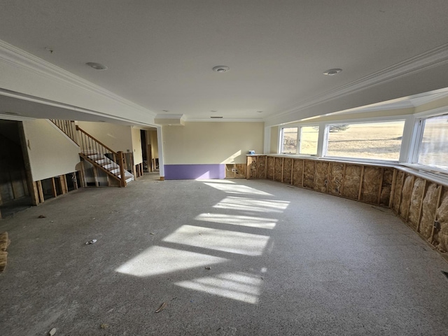 unfurnished living room featuring crown molding