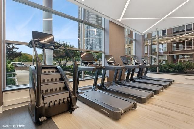 exercise room with hardwood / wood-style flooring and a wall of windows