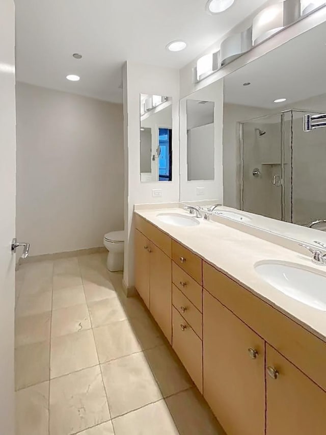 bathroom featuring vanity, an enclosed shower, tile patterned floors, and toilet