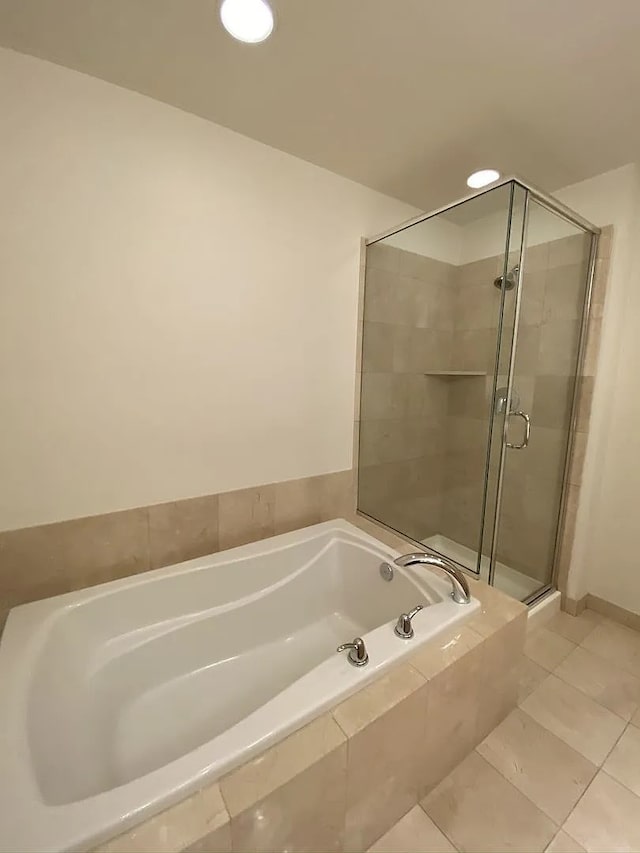 bathroom featuring tile patterned flooring and independent shower and bath